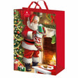 Christmas gift bag with Santa Claus design, featuring a fireplace and Christmas tree.