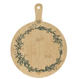 Round wooden cutting board with green leaf pattern on a white background