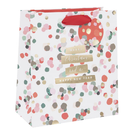 Gift bag with colorful polka dot pattern and Christmas text on a white background
