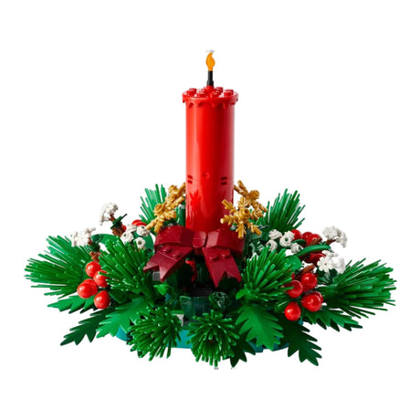 Decorative Christmas arrangement with a red candle, greenery, and berries on a white background